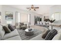 Bright living room with neutral tones, modern decor, and an open layout to the dining area at 1451 E Palm Beach Dr, Chandler, AZ 85249