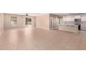Open-concept living area with tile flooring and access to backyard at 18009 W Ivy Ln, Surprise, AZ 85388
