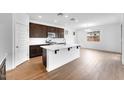 Bright kitchen featuring an island, modern appliances, and hardwood floors at 10864 E Texas Ave, Mesa, AZ 85212