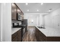 Stylish kitchen featuring granite countertops, stainless steel appliances, wood flooring, and recessed lighting at 24629 W St Catherine Ave, Buckeye, AZ 85326