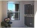 Front door with a security screen and small sitting area at 9612 E Champagne Dr, Sun Lakes, AZ 85248