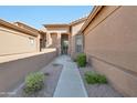 Inviting walkway to the front door, nicely landscaped at 9612 E Champagne Dr, Sun Lakes, AZ 85248