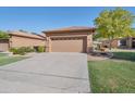 Two-car garage with a neutral-colored door and driveway at 9612 E Champagne Dr, Sun Lakes, AZ 85248