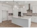 Bright kitchen features white cabinets, stainless appliances, quartz countertops, and pendant lighting at 12003 W Parkway Ln, Avondale, AZ 85323