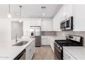 Bright kitchen with stainless steel appliances, a large island, and ample counter space with light backsplash at 5338 W Manzanita Dr, Glendale, AZ 85302