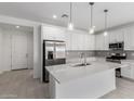 Bright and spacious kitchen featuring white cabinets, a large island, stainless steel appliances and stylish pendant lighting at 5344 W Manzanita Dr, Glendale, AZ 85302