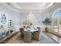 Elegant dining room features a round table with wicker chairs and a stunning chandelier at 5518 E Sanna St, Paradise Valley, AZ 85253