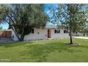 Ranch style home with a landscaped lawn, updated facade, and a large driveway at 934 E 8Th St, Mesa, AZ 85203