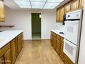 An open kitchen has lots of counter space and appliances, including oven and microwave at 10509 W Tropicana Cir, Sun City, AZ 85351