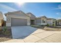 Two-car garage, gray exterior, and front yard landscaping at 5535 W St Moritz Ln, Glendale, AZ 85306