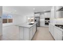 Spacious kitchen featuring an island, stainless appliances, and views into living spaces at 25118 N 171St Ln, Surprise, AZ 85387