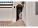 Inviting front entry with arched door and brick-paved walkway leading to the two-car garage at 25206 N 172Nd Ln, Surprise, AZ 85387