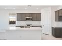Modern kitchen featuring an island, stainless steel appliances, and stylish gray cabinetry at 25206 N 172Nd Ln, Surprise, AZ 85387
