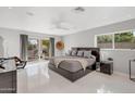 Bright bedroom with tile floors, modern furnishings, and a sliding door to the outdoor patio at 9175 N 82 St, Scottsdale, AZ 85258