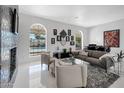 A bright living room featuring elegant decor, views of the pool, and a sleek modern design at 9175 N 82 St, Scottsdale, AZ 85258