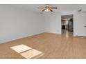 Bright living room with light wood floors and ceiling fan at 2106 E Greenway Dr, Tempe, AZ 85282