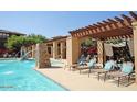 Relaxing pool area with pergola, lounge chairs, and water features at 20100 N 78Th Pl # 2143, Scottsdale, AZ 85255