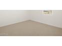 Simple bedroom with neutral carpeting and a window at 36833 W La Paz St, Maricopa, AZ 85138