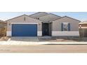 Single-story home with a two-car garage and landscaped yard at 36833 W La Paz St, Maricopa, AZ 85138
