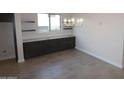 Dining area with storage, granite counters, and a modern chandelier at 19964 W Marshall Ave, Litchfield Park, AZ 85340