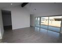 Bright living room with a large window and a sliding door offering plenty of natural light at 19964 W Marshall Ave, Litchfield Park, AZ 85340