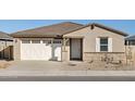 Single story home with a two-car garage and desert landscaping at 37422 W San Clemente St, Maricopa, AZ 85138