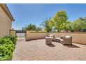 Charming courtyard with comfortable seating and lush landscaping at 12368 W Running Deer Trl, Peoria, AZ 85383