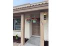 Close up of a Front Porch with Hanging Flower baskets near the front door at 2142 E Donner Dr, Tempe, AZ 85282