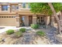 Attractive home with a welcoming front porch and nicely landscaped yard with stone accents at 35202 N 30Th Dr, Phoenix, AZ 85086