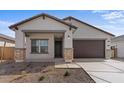 Inviting home featuring stone accents, a covered entry, and desert landscaping at 16625 N Lunar St, Maricopa, AZ 85138