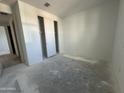 Well-lit bedroom featuring a double-door closet at 22857 E Roundup Way, Queen Creek, AZ 85142