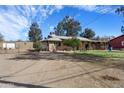 Charming single-story home with a covered porch, mature trees, and a spacious dirt front yard at 26415 S Recker Rd, Queen Creek, AZ 85142