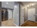 Entryway with tile flooring, and adjacent kitchen at 22142 N Braden Rd, Maricopa, AZ 85138