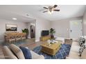 The bright living room boasts wood flooring, a ceiling fan, and comfortable seating around a wooden coffee table at 2633 W Ocotillo Rd # 3, Phoenix, AZ 85017