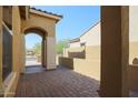 Brick paved courtyard with archway and adjacent wall at 14133 S 179Th Ave, Goodyear, AZ 85338