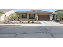 One-story home with tile roof, shutters, and attached garage at 14133 S 179Th Ave, Goodyear, AZ 85338