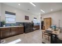Well-equipped laundry room with built-in cabinets and countertops, perfect for organization and convenience at 14133 S 179Th Ave, Goodyear, AZ 85338