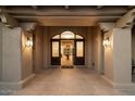 Elegant entryway with arched doorway and beautiful glass accents at 7628 E Mary Sharon Dr, Scottsdale, AZ 85266