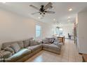 Open concept living room with grey sectional sofa and kitchen views at 3559 E Archer Dr, San Tan Valley, AZ 85140