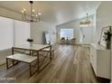 Dining room showcases wood flooring and a modern table with marble top and metal frame at 5984 W Geronimo Ct, Chandler, AZ 85226