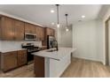 Contemporary kitchen features stainless appliances, a stylish island, and elegant pendant lights at 2878 N Evergreen St, Buckeye, AZ 85396