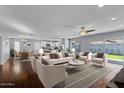 Bright and spacious open-concept living room with modern furnishings, and kitchen/dining areas in the background at 2409 E Hampton Ave, Mesa, AZ 85204