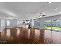 Open-concept living space with hardwood floors, modern lighting, and a view of the backyard at 2409 E Hampton Ave, Mesa, AZ 85204
