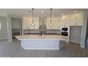 Spacious kitchen featuring a large center island, stainless steel appliances, and ample cabinet space at 12315 W Parkway Ln, Avondale, AZ 85323