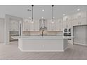 Bright kitchen featuring white cabinets, quartz counters, and stainless steel appliances at 12315 W Parkway Ln, Avondale, AZ 85323