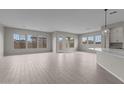 Bright living room with light wood flooring and large windows providing natural light at 12315 W Parkway Ln, Avondale, AZ 85323
