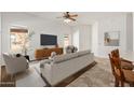 Bright living room with neutral tones, tiled floors, and a ceiling fan at 26 S Quinn Cir # 7, Mesa, AZ 85206