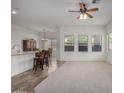 Bright living room with a breakfast bar, tile floors, and large windows offering ample natural light at 26 S Quinn Cir # 7, Mesa, AZ 85206