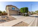 Two-story home featuring a well-maintained lawn, mature tree, two-car garage, and inviting curb appeal at 272 N 167Th Ln, Goodyear, AZ 85338