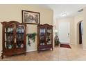 Bright and spacious entryway with tile flooring and elegant display cabinets at 35518 N 30Th Dr, Phoenix, AZ 85086